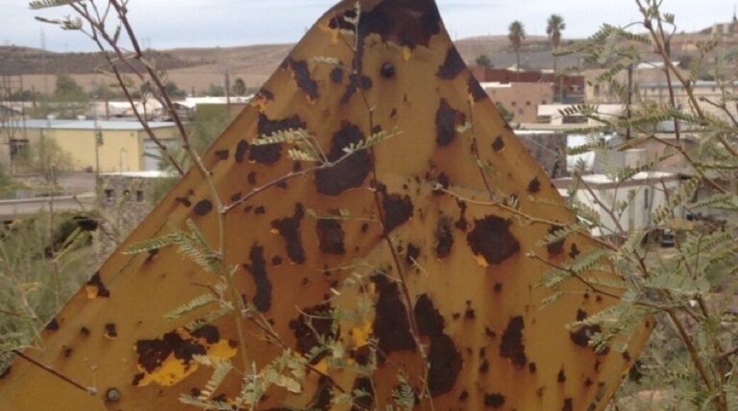 Old road sign at the west end of the old Highway 60 in Superior. You can barely make it out, but it says the road curves to the right.
