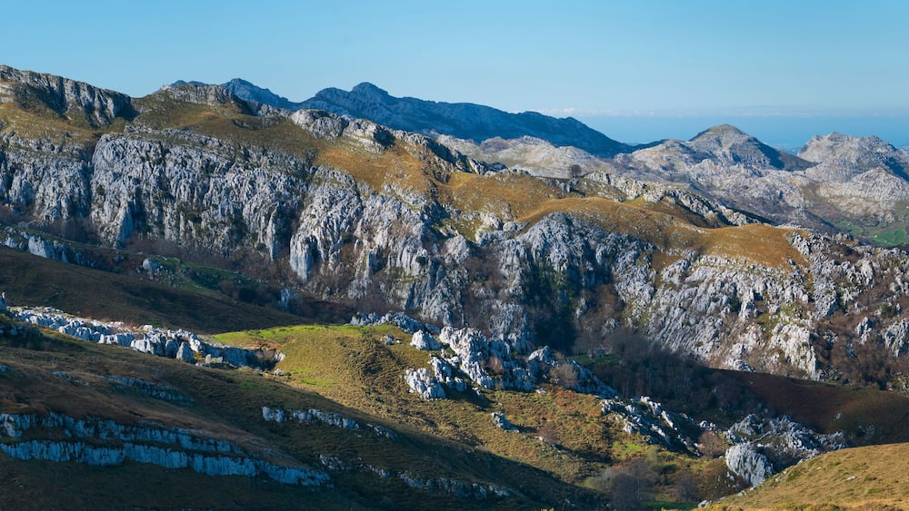 Einsame Berge mit schroffen Felsen und kargen Pflanzen.