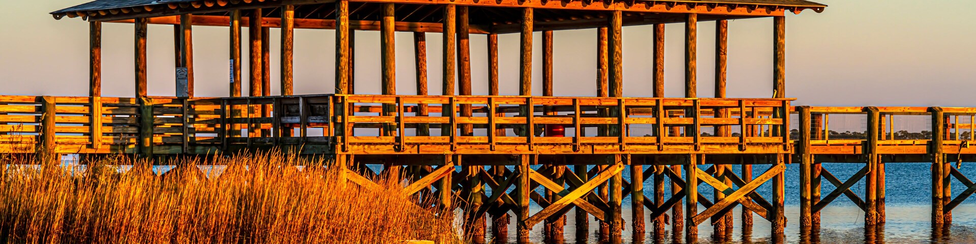 Pier plus covered picnic areas on the Gulf in Long Beach Mississippi area, late light.