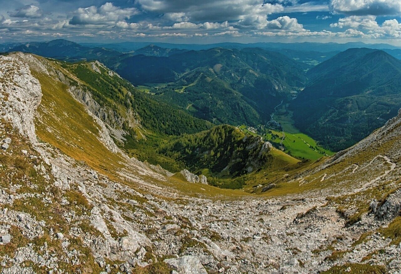 A mountainous landscape with rocky terrain and lush green valleys.