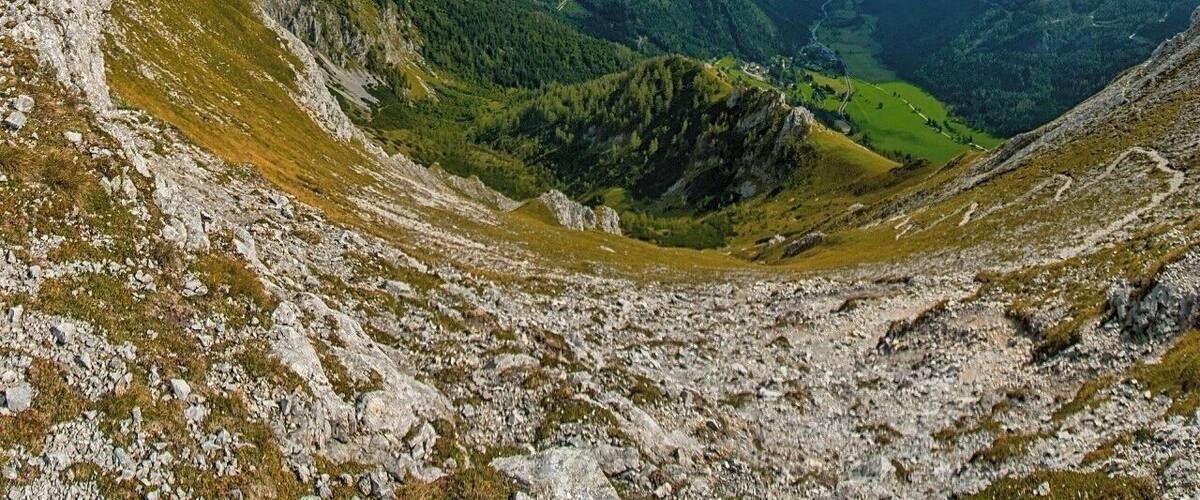 A mountainous landscape with rocky terrain and lush green valleys.
