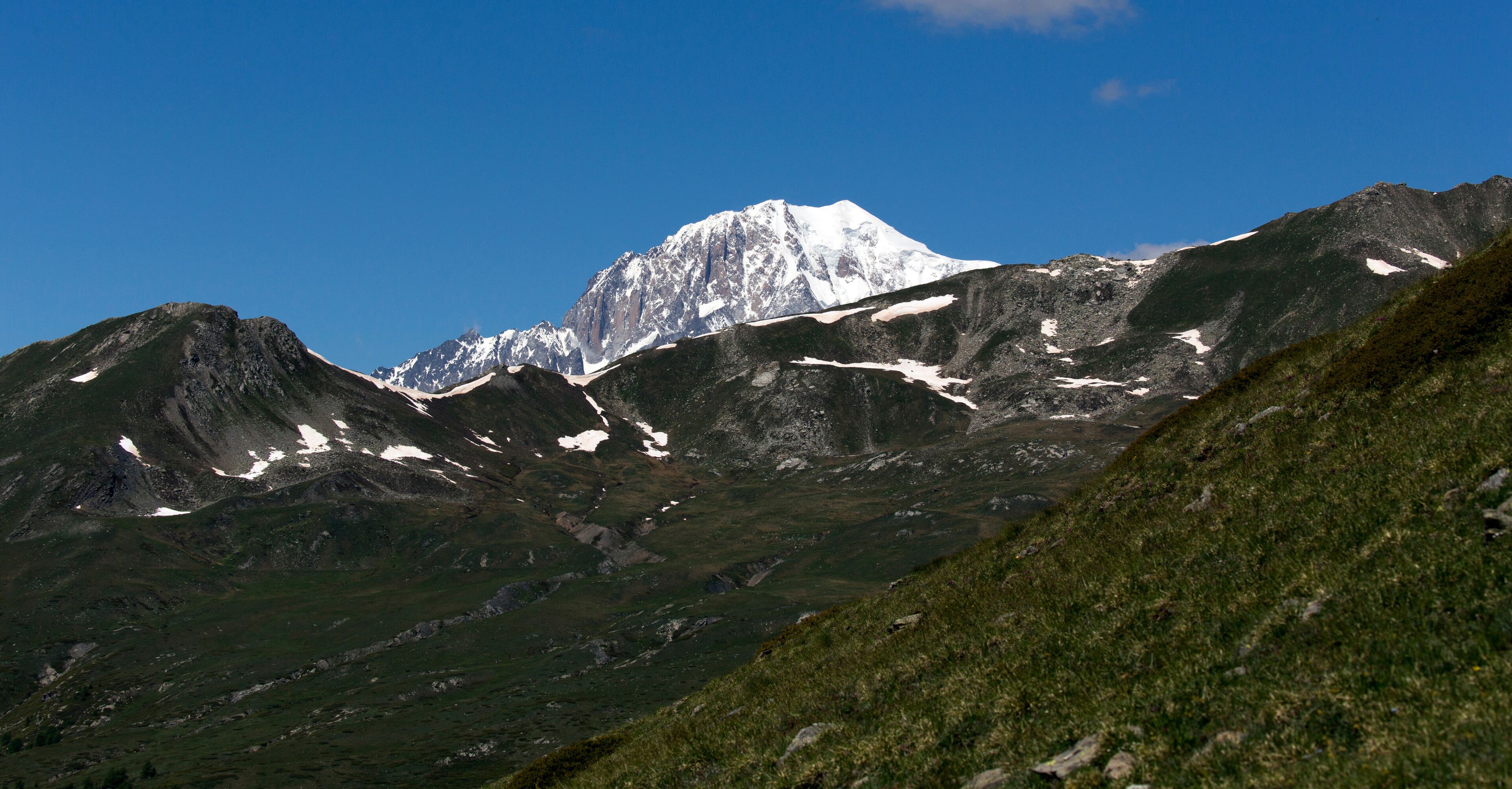 A snow-capped mountain range with a clear blue sky.