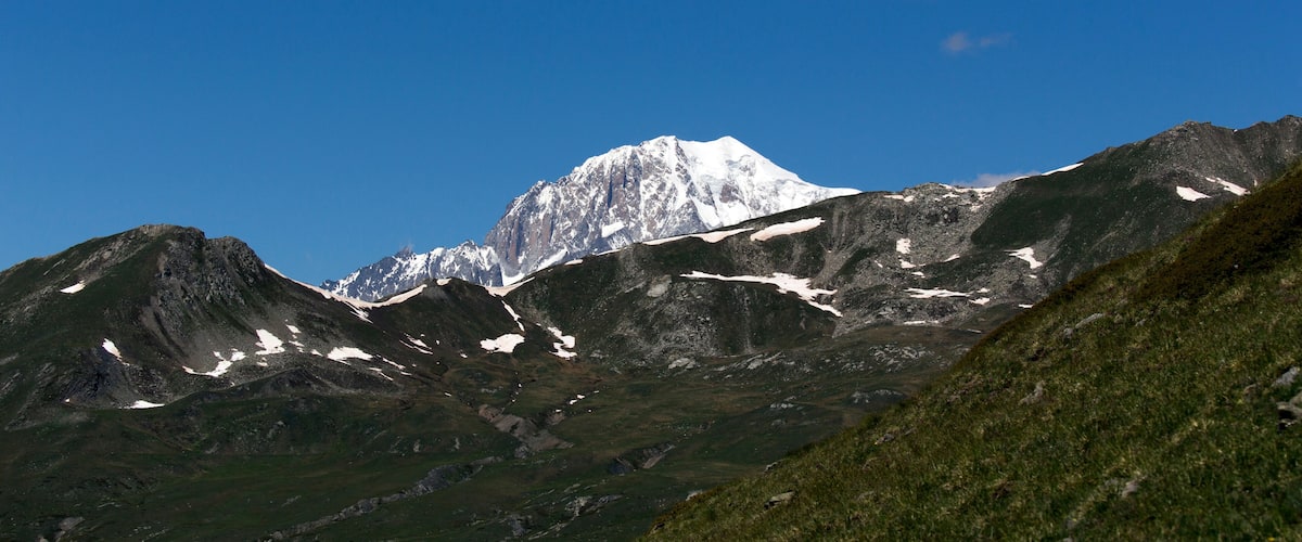 A snow-capped mountain range with a clear blue sky.