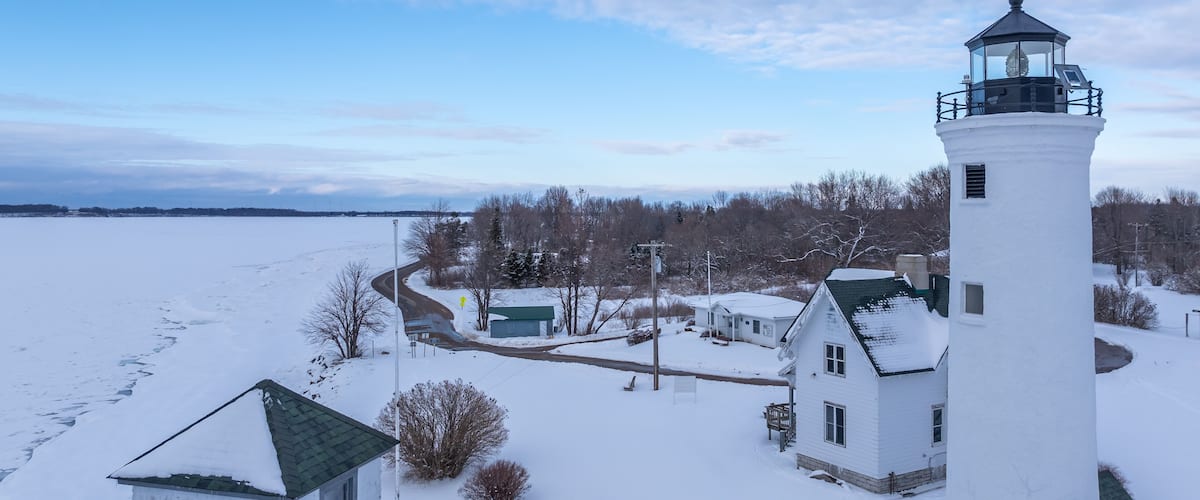 Winter aerial view Tibbetts Point Lighthouse on the shore of Lake Ontario, at the entrance of the St Lawrence River in Cape Vincent, New York.