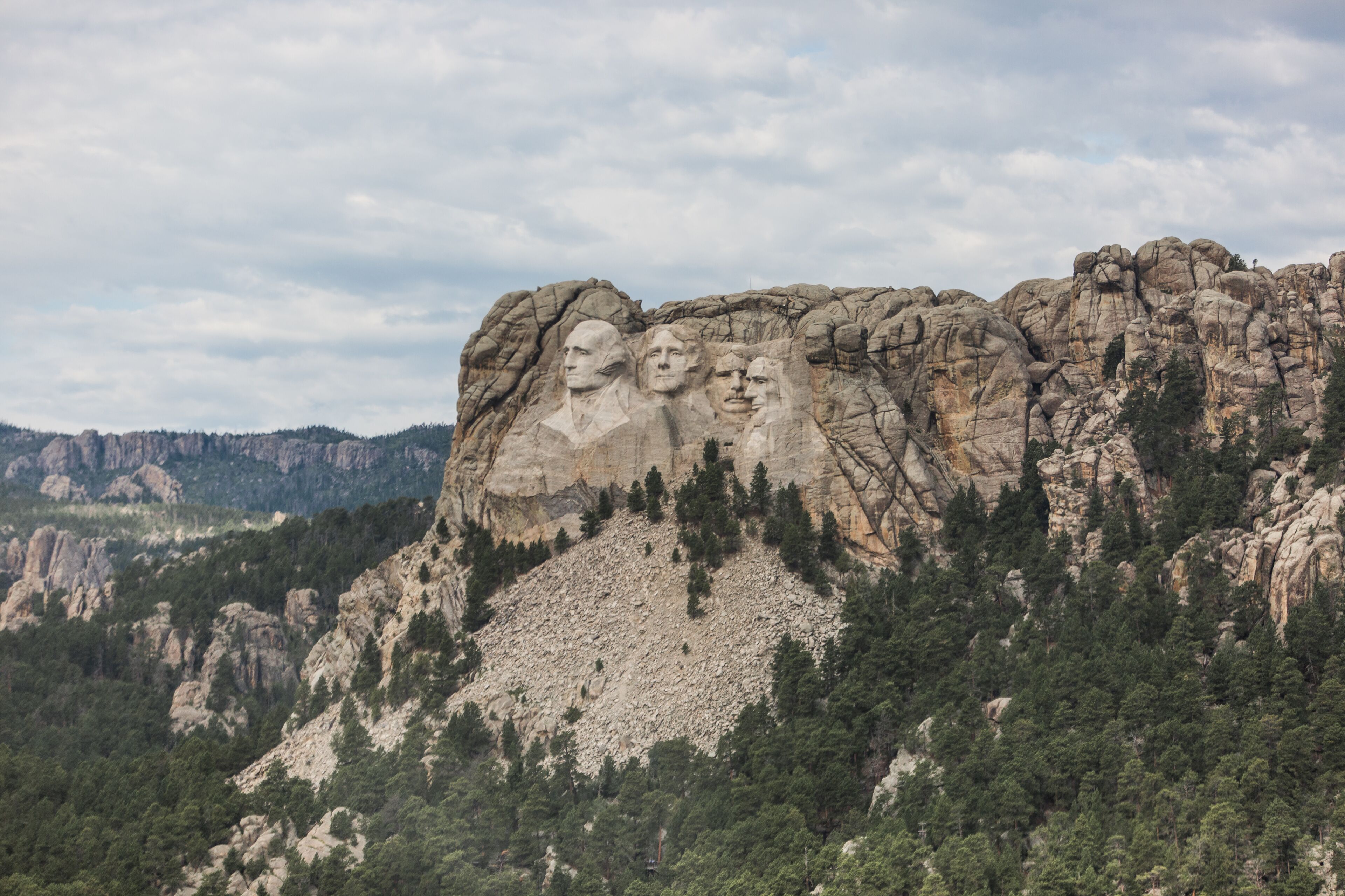 Mount Rushmore with four presidential faces carved into the rock.
