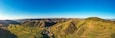 Germany, Baden-Wurttemberg, Vogtsburg im Kaiserstuhl, Aerial panorama of vineyards and volcanic hills of Kaiserstuhl in autumn