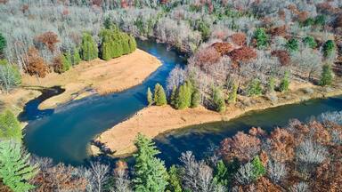 Winding river does 180 twist in late fall from aerial view