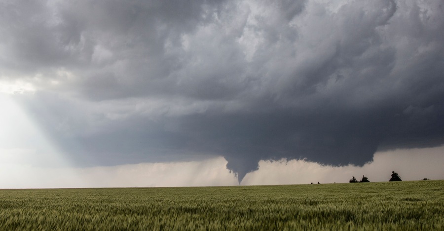 Crepuscular rays wrap around the rear flank downdraft of tornadic thunderstorm over the open plains