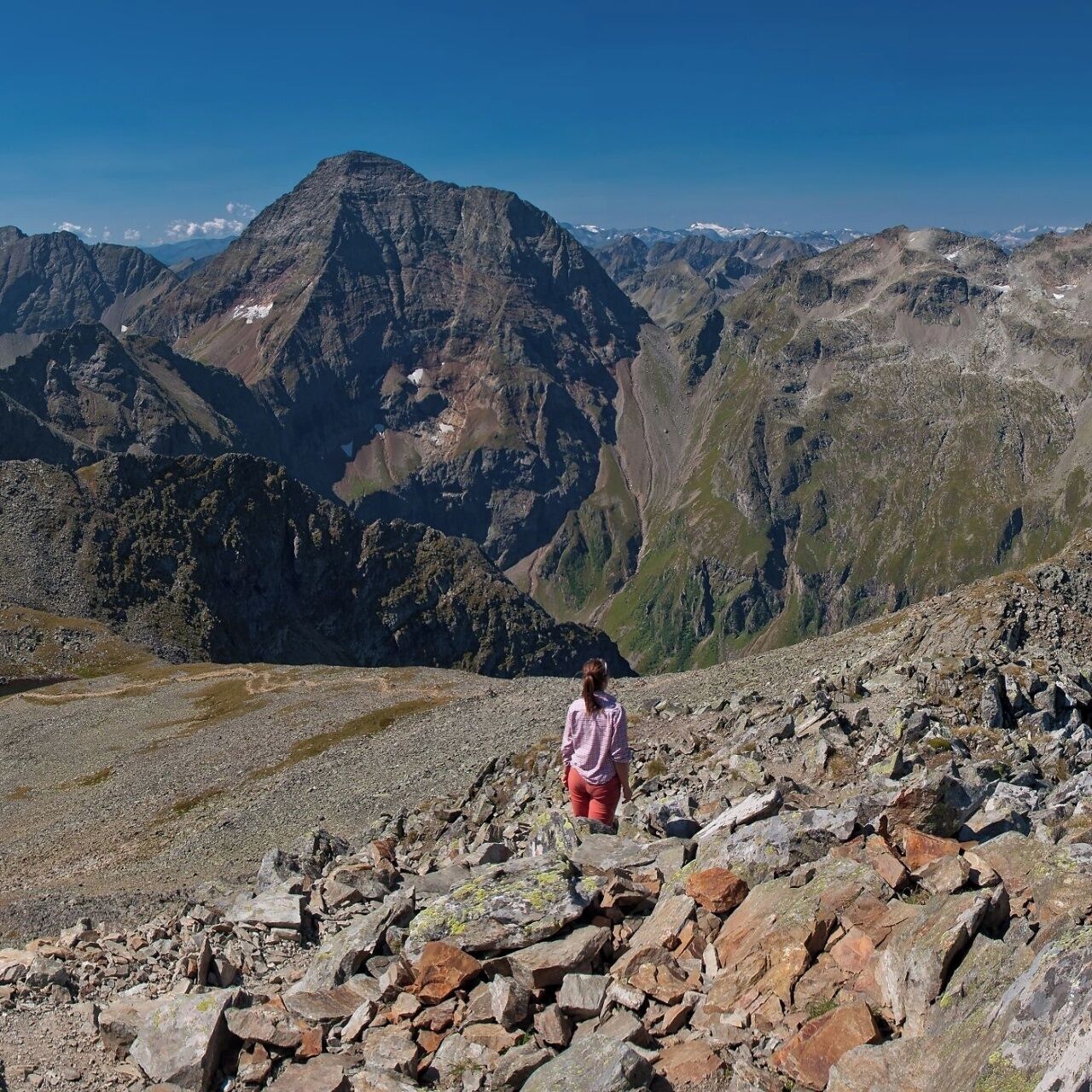 A rocky mountain landscape with a prominent peak in the background.