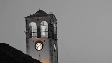 A clock tower with a dome and two visible clocks.