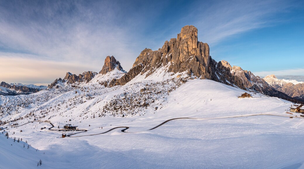 A snow-covered mountain peak with a ski resort and a clear sky.