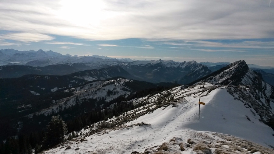 The Mittaggüpfi belongs to the Mt. Pilatus chain and from the top you can see a lot of Switzerland and the Alps. 
You best start in the "Stäfeli" and just follow the marked path till you get to the top which takes around 1.5h. It is quite steep but not dangerous.