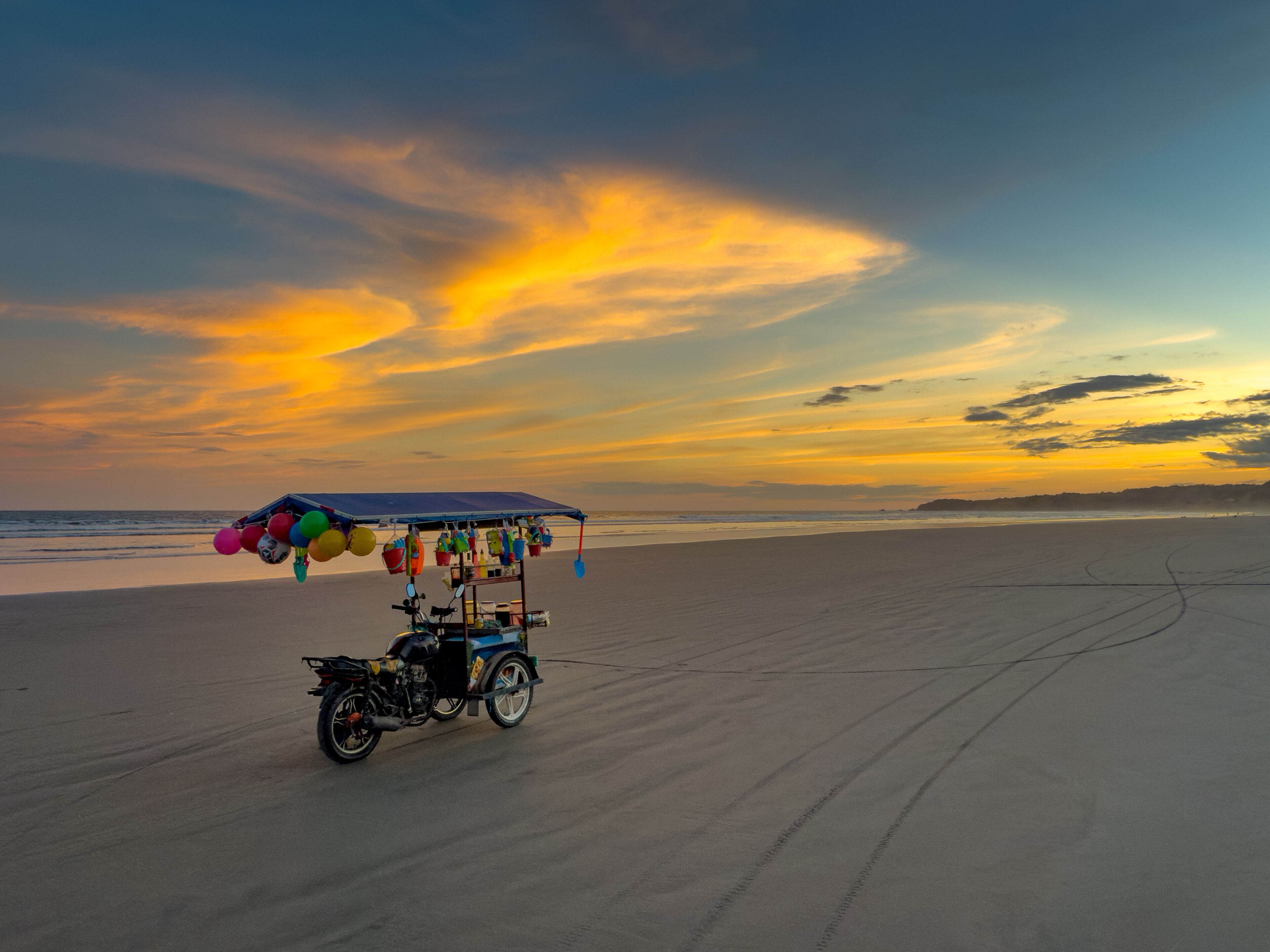 Colorful Vendor Cart on Beach at Sunset
