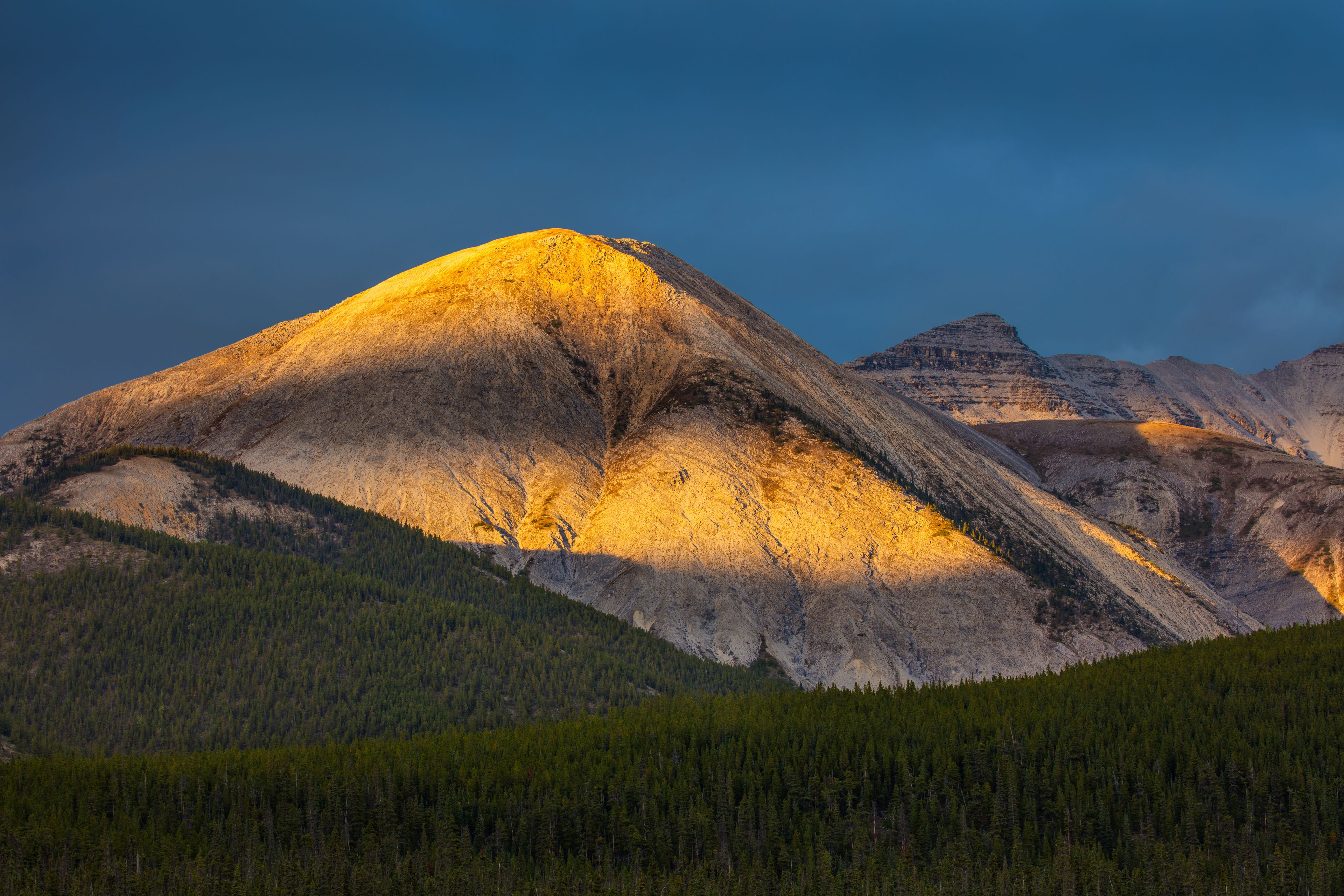 Sunset over the barren mountains of Muncho Lake Provincial Park, British Columbia Canada