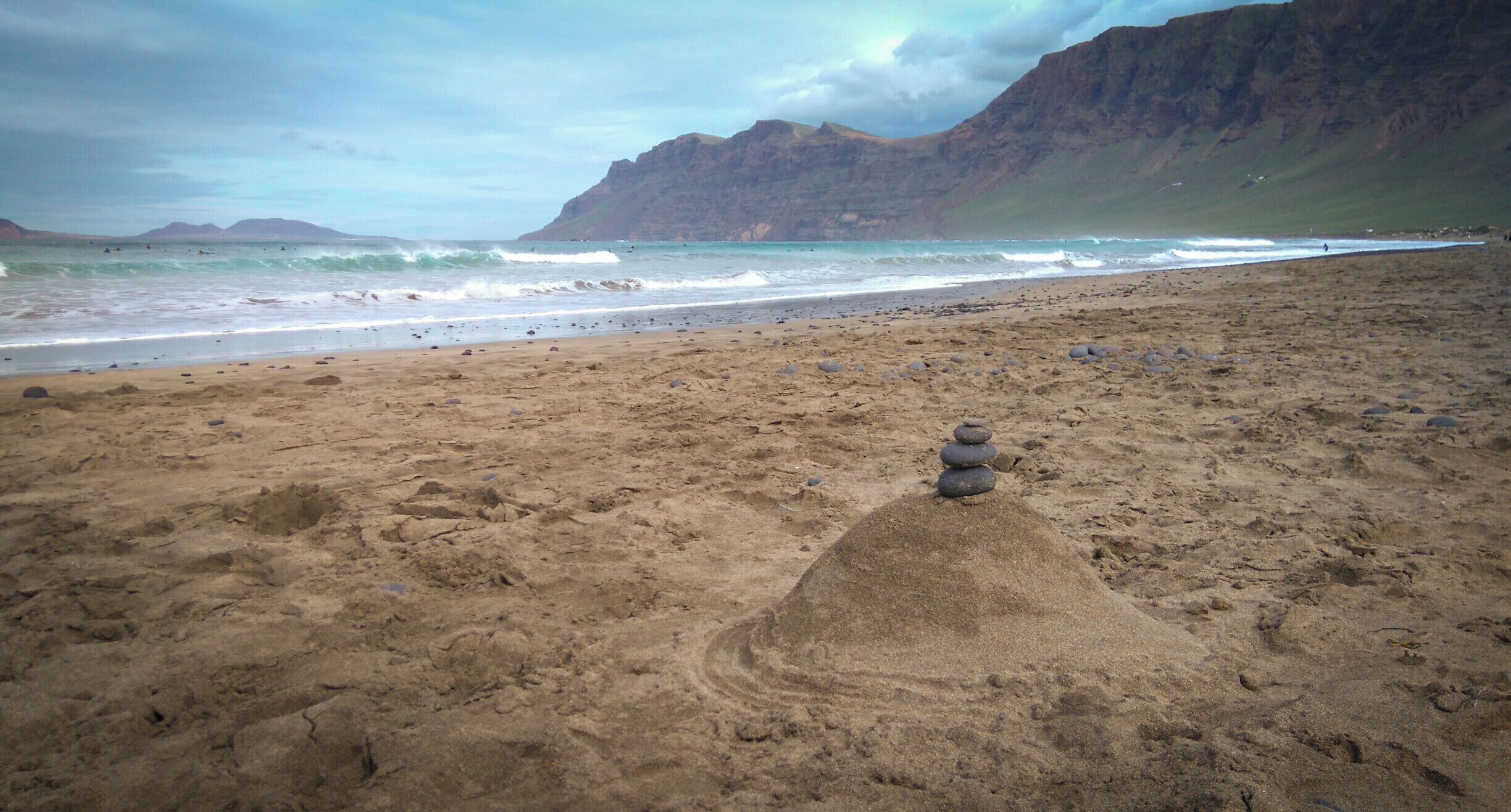 We were glad that we chose Kalufa Surf School. I was not the best student, but I am sure I was amongst the funniest. So was the entire staff and we said goodbye as friends. 
Pictured: Playa de Famara, which welcomed us every single morning with a ton of foam. Plus, the sand castle built by us as a trademark of our team.
#waterlust

P.S. Is a surf camp right for you (link in Romanian)?
https://bit.ly/33Zmo31