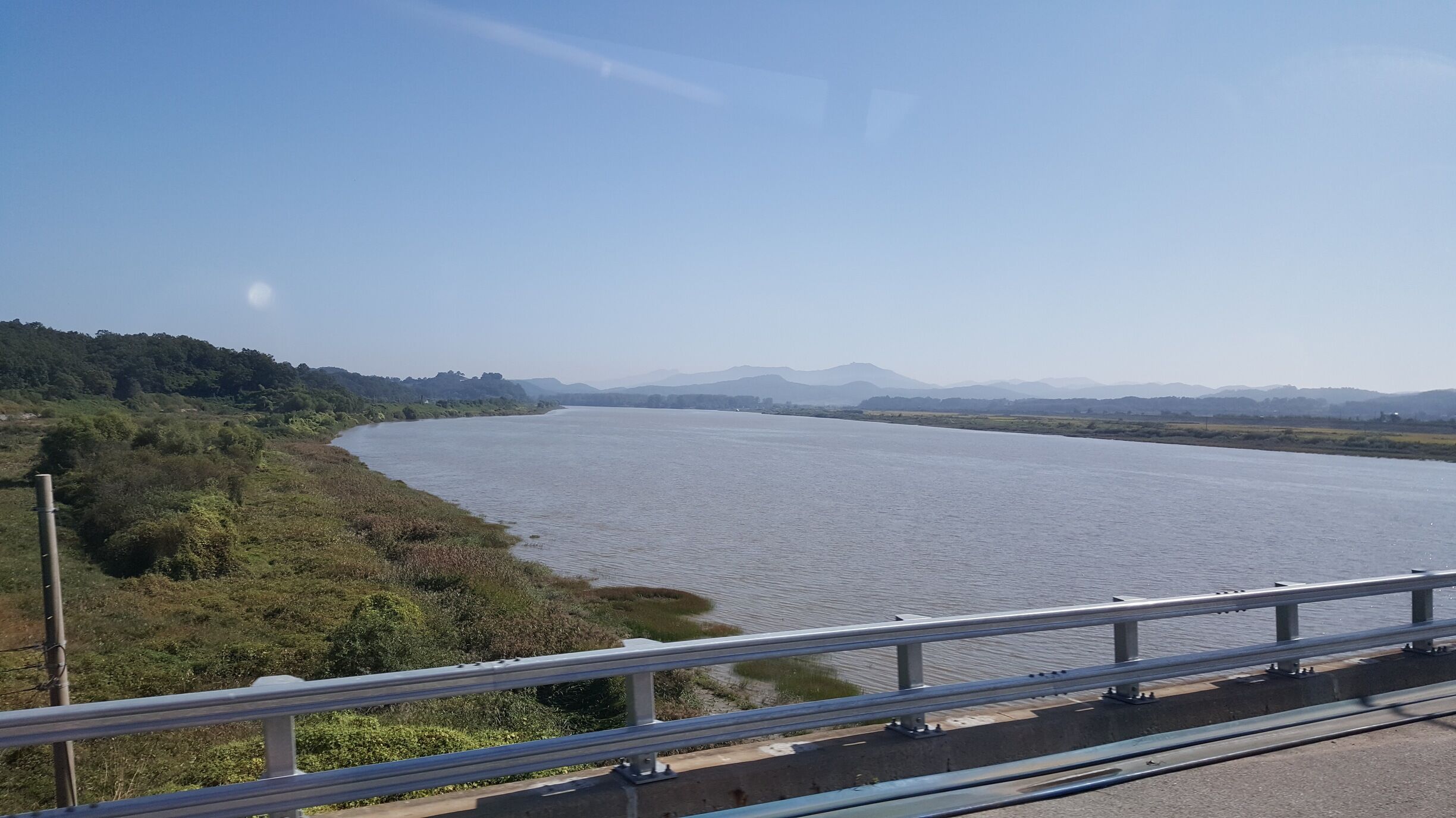 On the Unification Bridge.
Can see the hills of North Korea . Beautiful landscape.The tales of separation of the two states were really sad.Looks so peaceful, but this is one of the most heavily militarized  zone on Planet. 