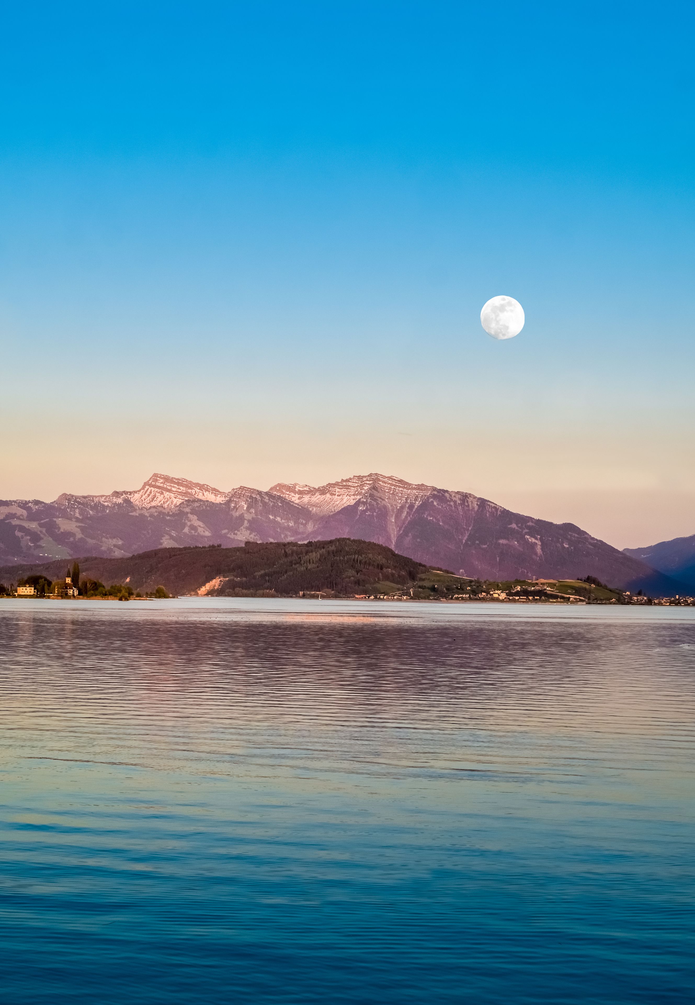 Full moon over the upper lake Zurich (Obersee) at dusk, Rapperswil, Sankt Gallen, Switzerland