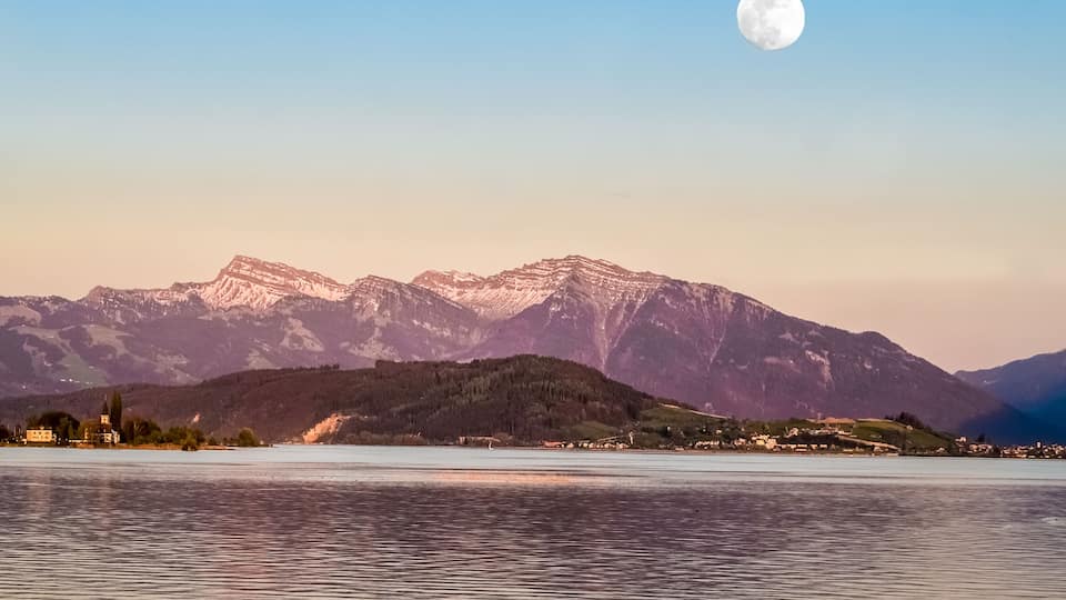 Full moon over the upper lake Zurich (Obersee) at dusk, Rapperswil, Sankt Gallen, Switzerland