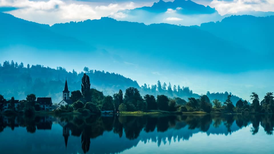 The charming village of Busskirch (Kirchdorf), Rapperswil-Jona, Sankt Gallen, Switzerland. Located in an idyllic lakeside shore of the Obersee (Upper Lake Zurich) .