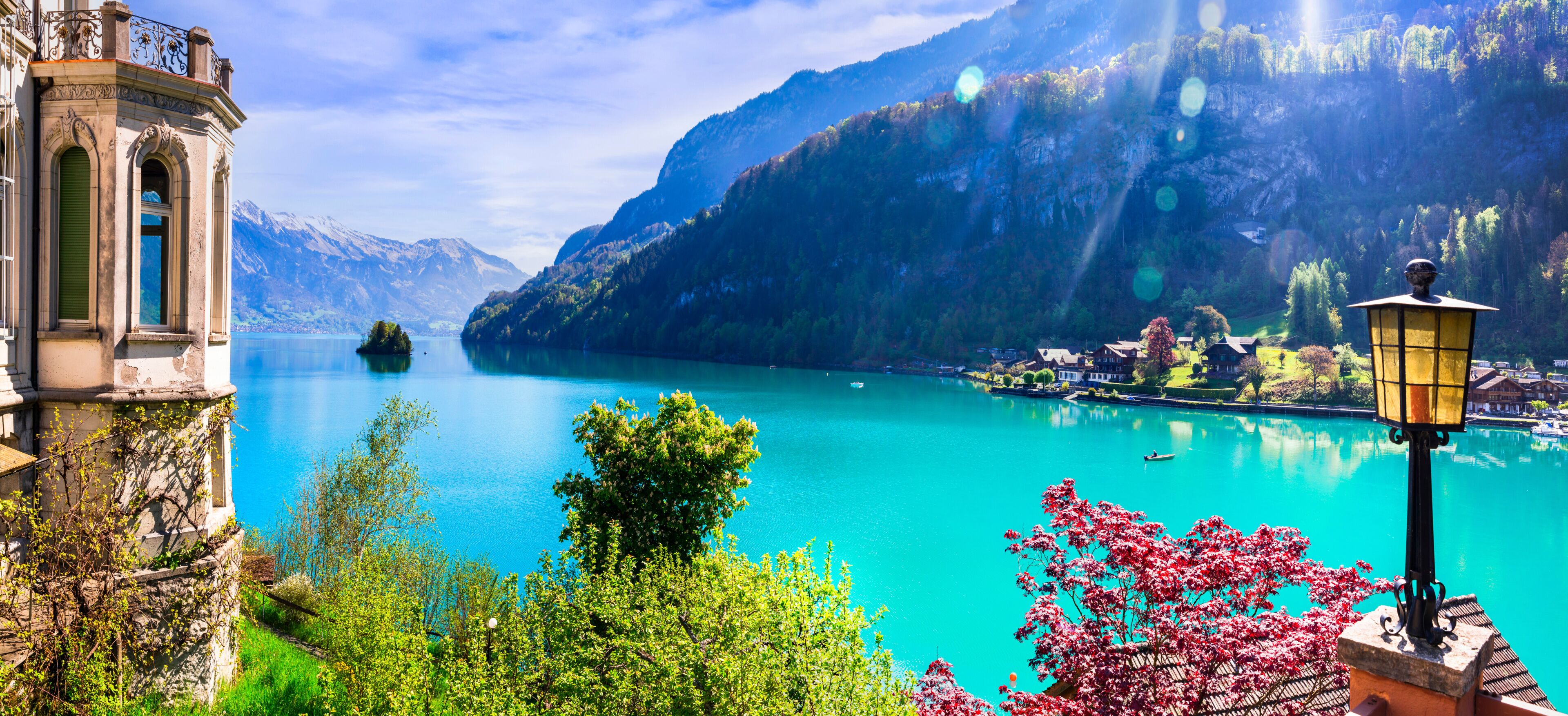 Stunning idylic nature scenery of lake Brienz with turquoise waters. Switzerland, Bern canton. Iseltwald village surrounded turquoise waters