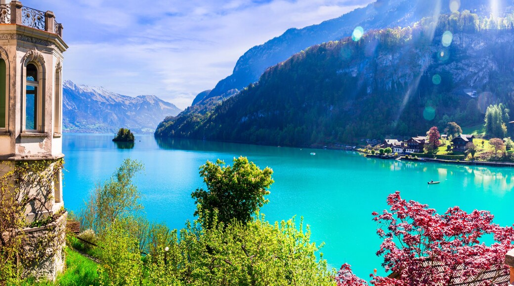 Stunning idylic nature scenery of lake Brienz with turquoise waters. Switzerland, Bern canton. Iseltwald village surrounded turquoise waters