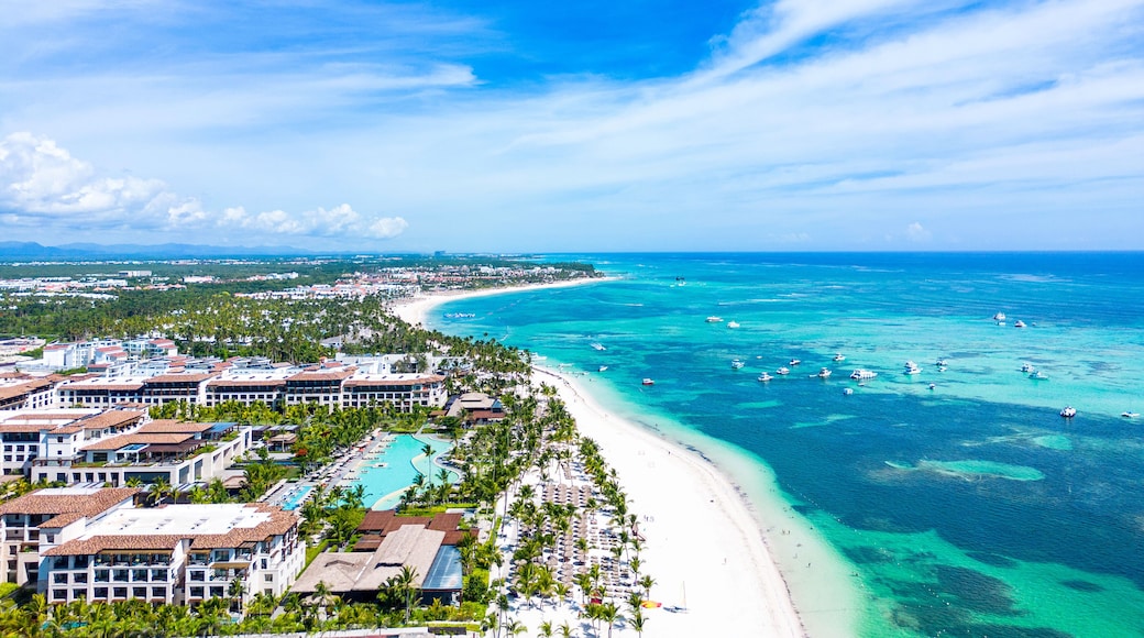Aerial view of the Punta Cana beach with white sand and turquoise water of the Caribbean Sea. Top places for summer vacations in all Inclusive resorts and hotels in Dominican Republic