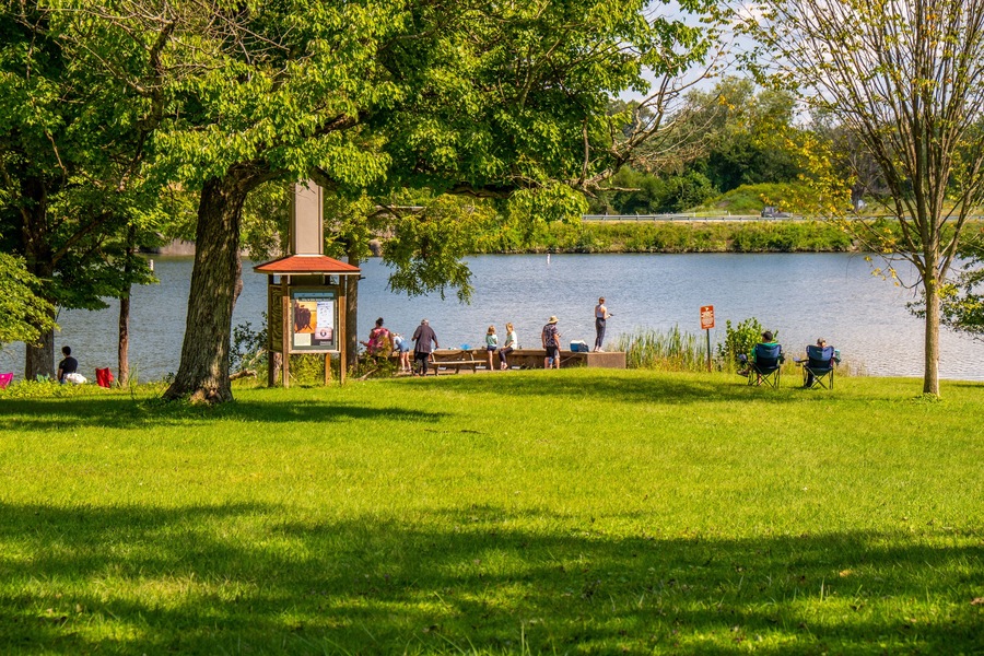Great day to be in the park. Time for fishing and catching fish. Beautiful sunny day in summer time where people can do outdoor activities