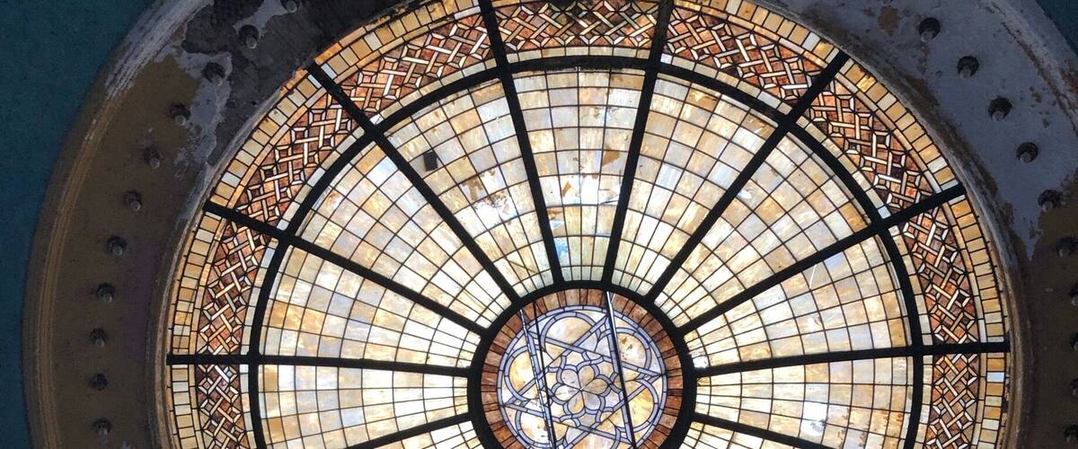 A circular stained glass window with intricate patterns.