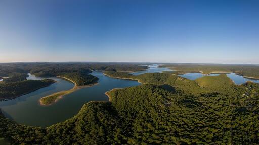 A river winding through a forested landscape with multiple lakes.