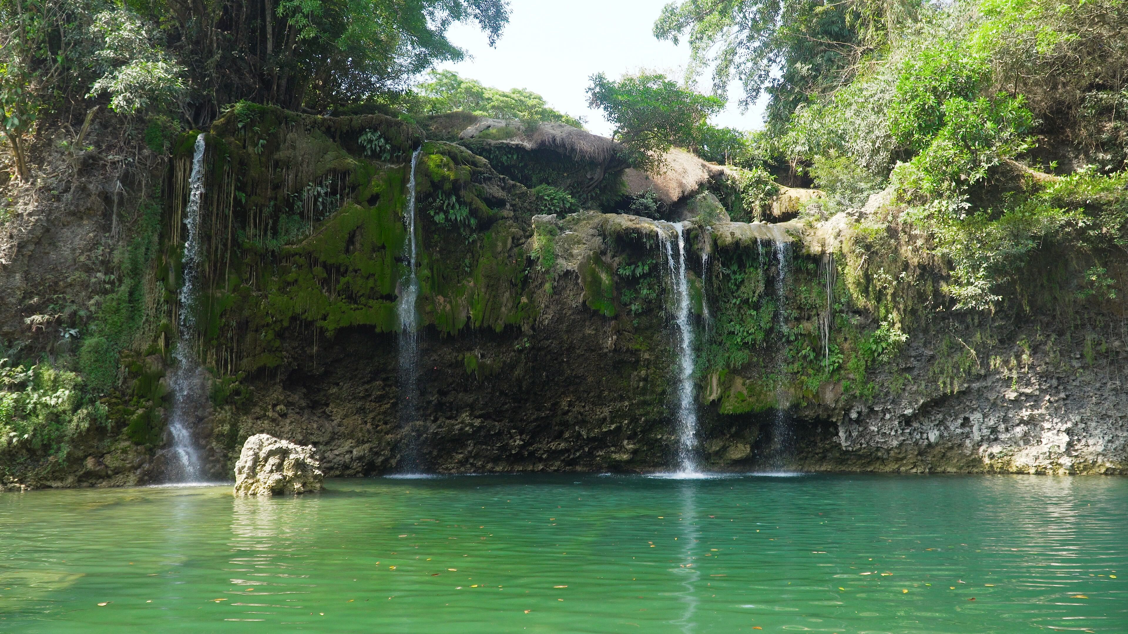 Waterfall in green rainforest. Bolinao waterfall in the mountain jungle. Philippines, Luzon. Travel concept.