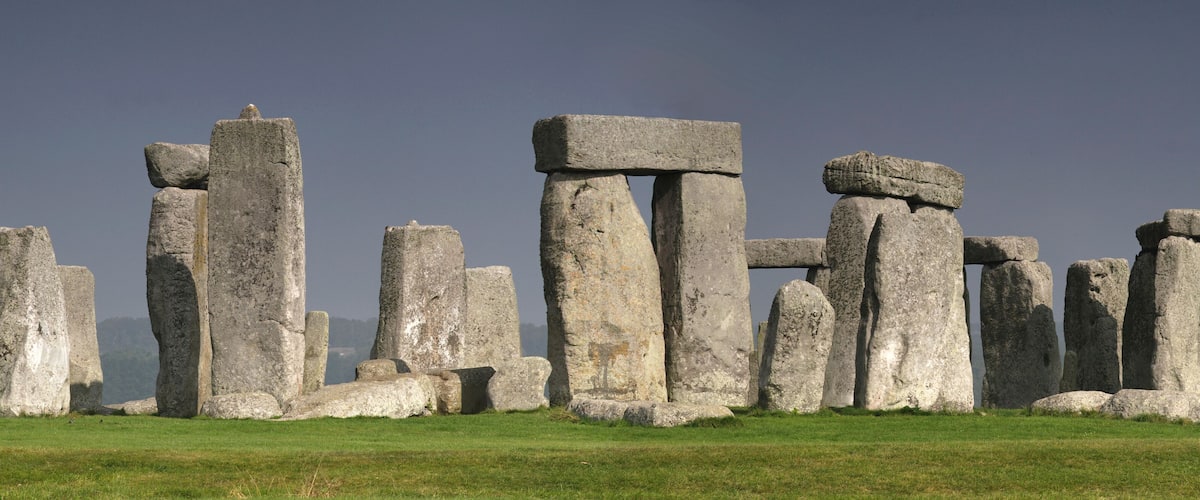 Stonehenge standing in a grassy field.