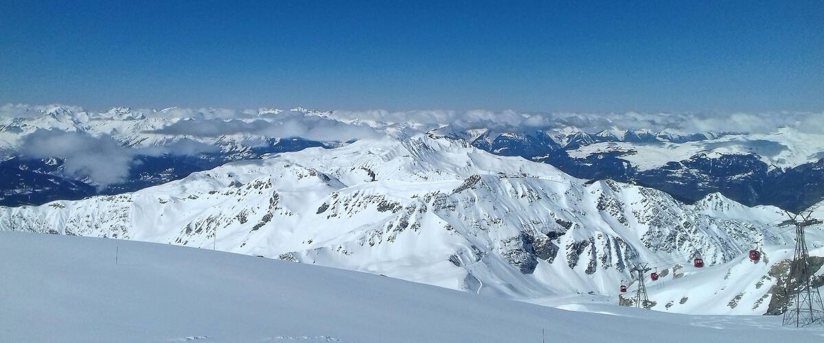 A snow-covered mountain range with clear skies.