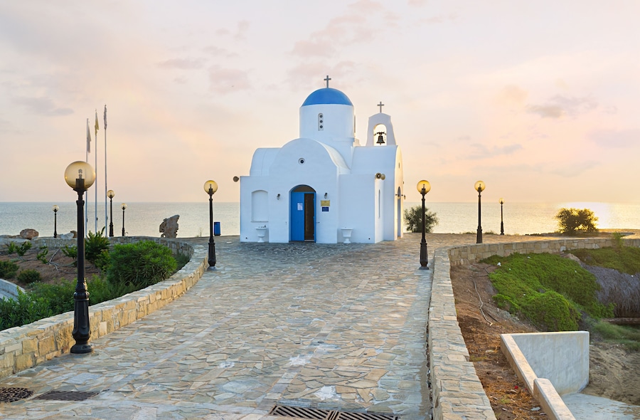 The coastal church of Agios Nikolaos located next to the Golden Coast harbor on the scenic promenade, Protaras, Cyprus.; Shutterstock ID 242589805