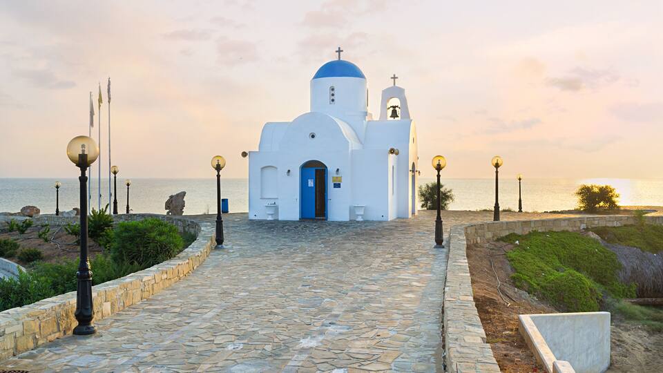 The coastal church of Agios Nikolaos located next to the Golden Coast harbor on the scenic promenade, Protaras, Cyprus.; Shutterstock ID 242589805