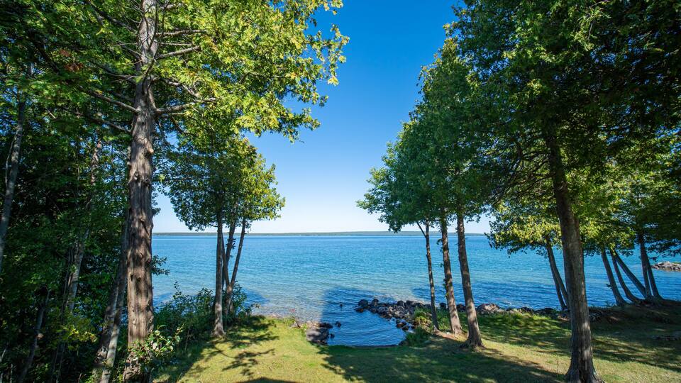 View to the beautiful Lake Manitou from the cabin. Amazing sky line landscape with trees and water. Canadian wilderness. Perfect spot for a holiday. Cottage located on the largest fresh water island.