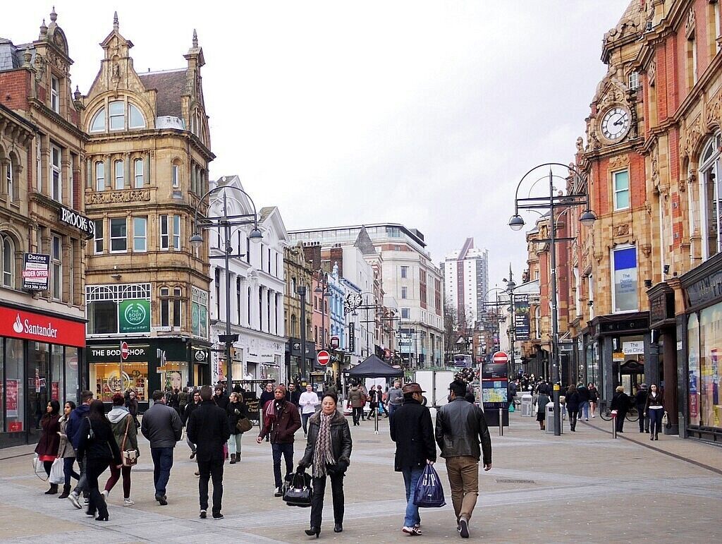A busy urban street lined with historic buildings and shops.