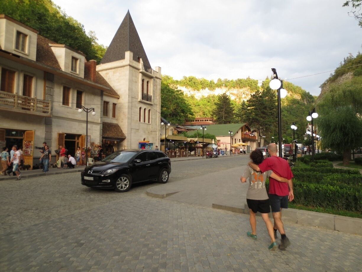 Young couple walking down a street in Borjomi, Georgia.

Borjomi is a resort town, located roughly 75 miles to the west of the Georgian capital of Tbilisi.

This area has long been a retreat area - starting first during the Russian empire, continuing on during the Soviet times, and onto today.
