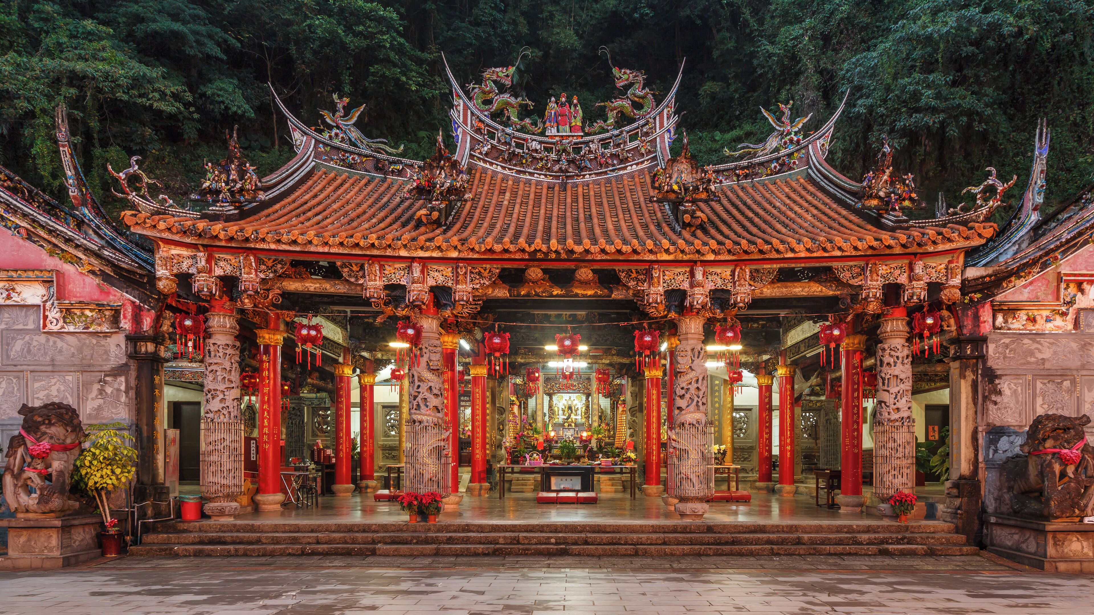 A traditional Chinese temple with ornate architecture, red lanterns, and intricate carvings.