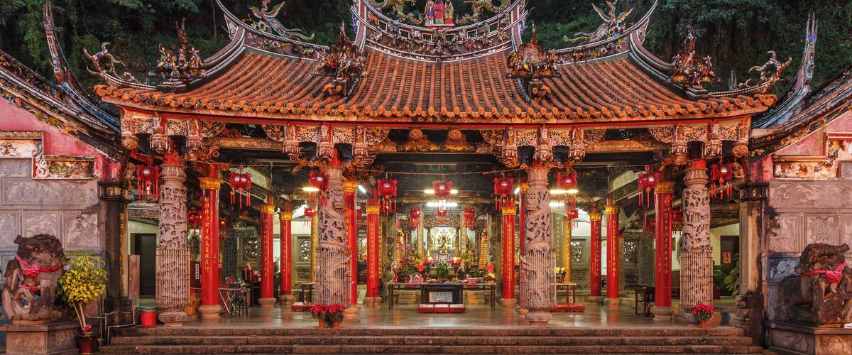 A traditional Chinese temple with ornate architecture, red lanterns, and intricate carvings.