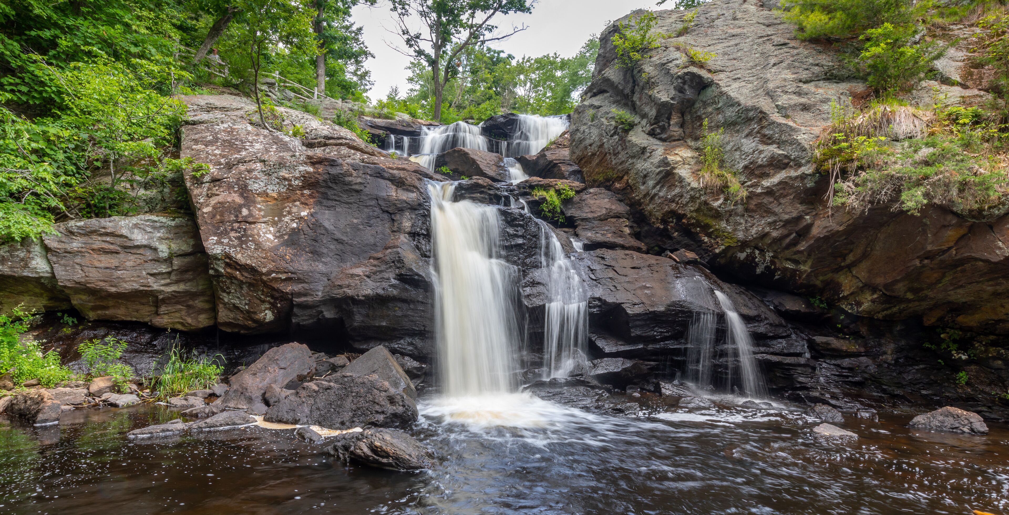 Landscape with waterfall, rocks and leafy green trees at Eightmile River,Chapman Falls, East Haddam, Connecticut Devil's Hopyard State Park