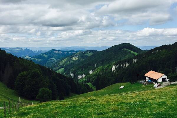 Hiking near Wassefallen, Switzerland. Take public transport from Basel to the picturesque town of Reigoldswil where there is a cable car into the mountains. At the top are hiking trails, a ropes/zip line course, cafes, and picnic sites. Hike up to the ridge - on a clear day, you can see the Alps. To get down, you have the option to walk, ride the cable car, or rent adult-sized scooters to glide back to town. Great day trip from Basel!