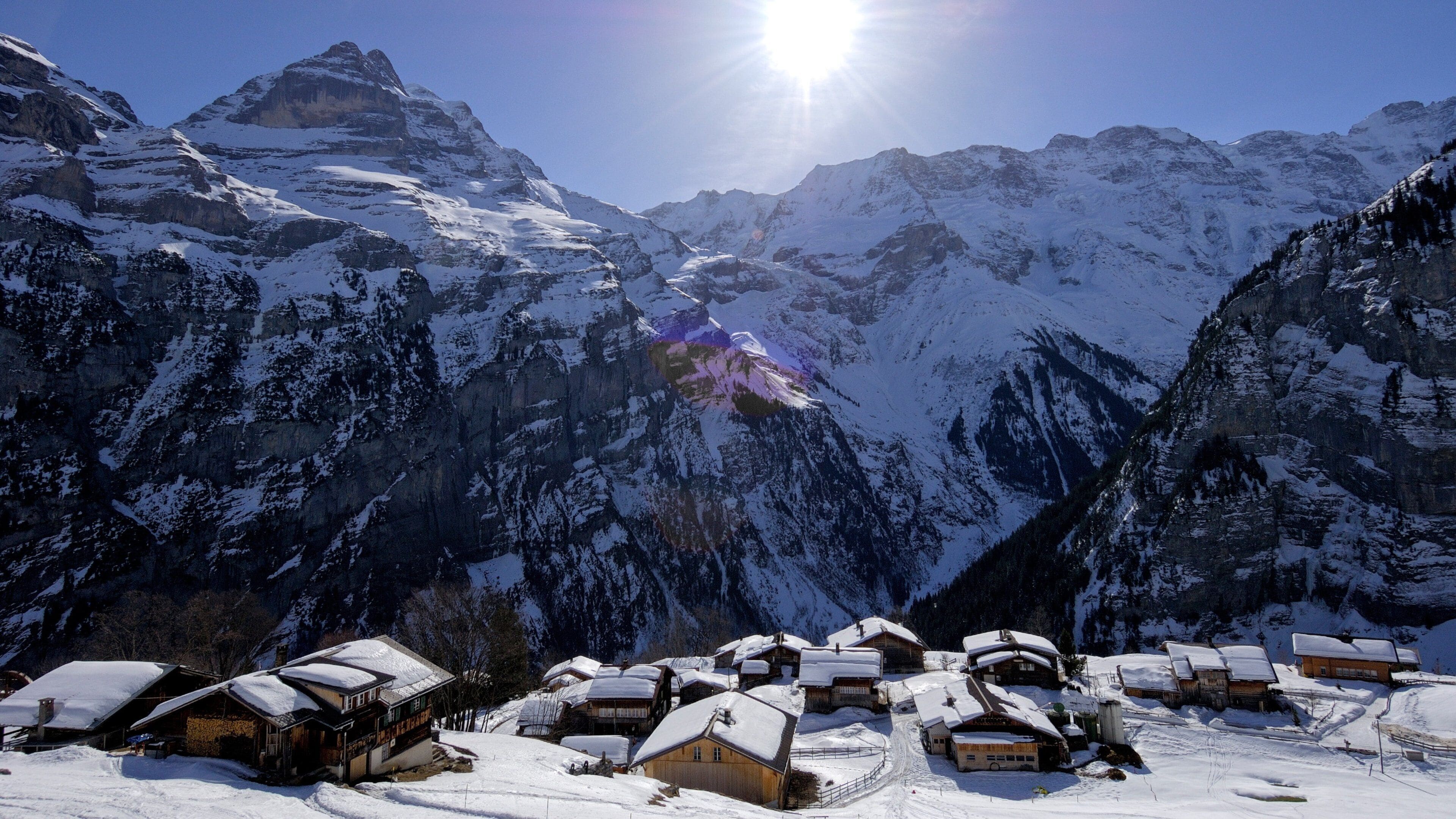Gimmelwald which includes snow, a small town or village and mountains