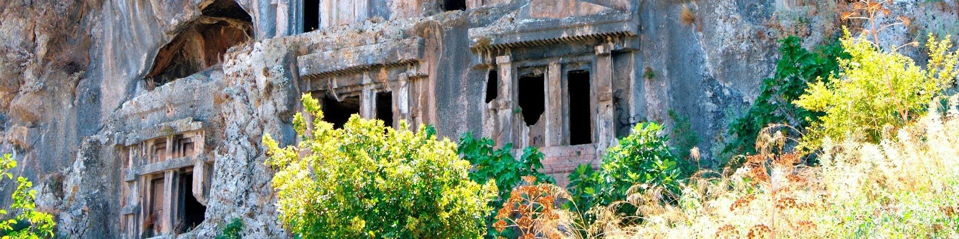 Ancient rock-cut architecture with multiple niches and windows.