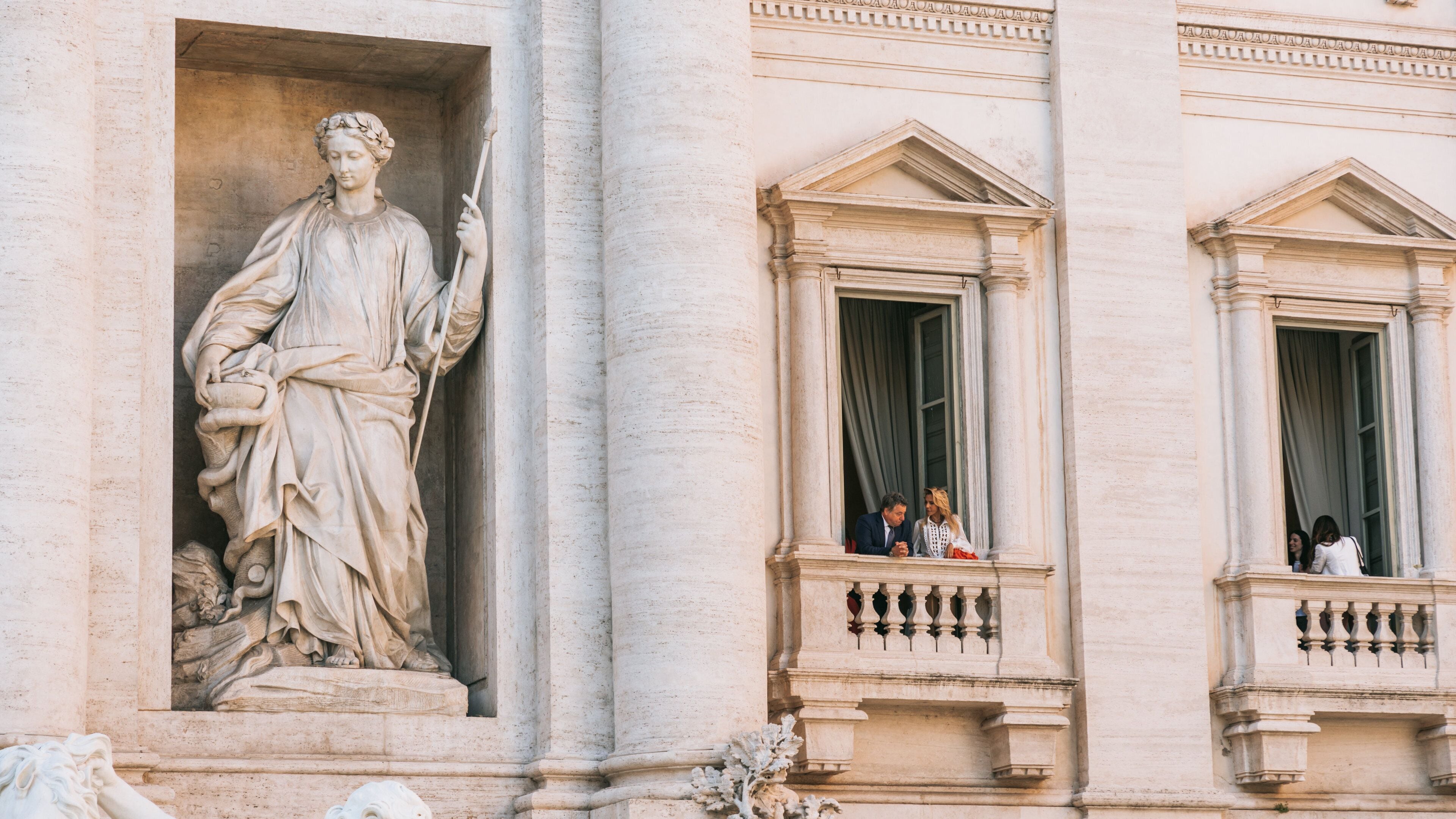 Trevi Fountain which includes a statue or sculpture and heritage elements as well as a couple