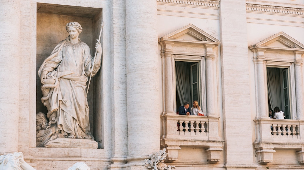 Trevi Fountain which includes a statue or sculpture and heritage elements as well as a couple