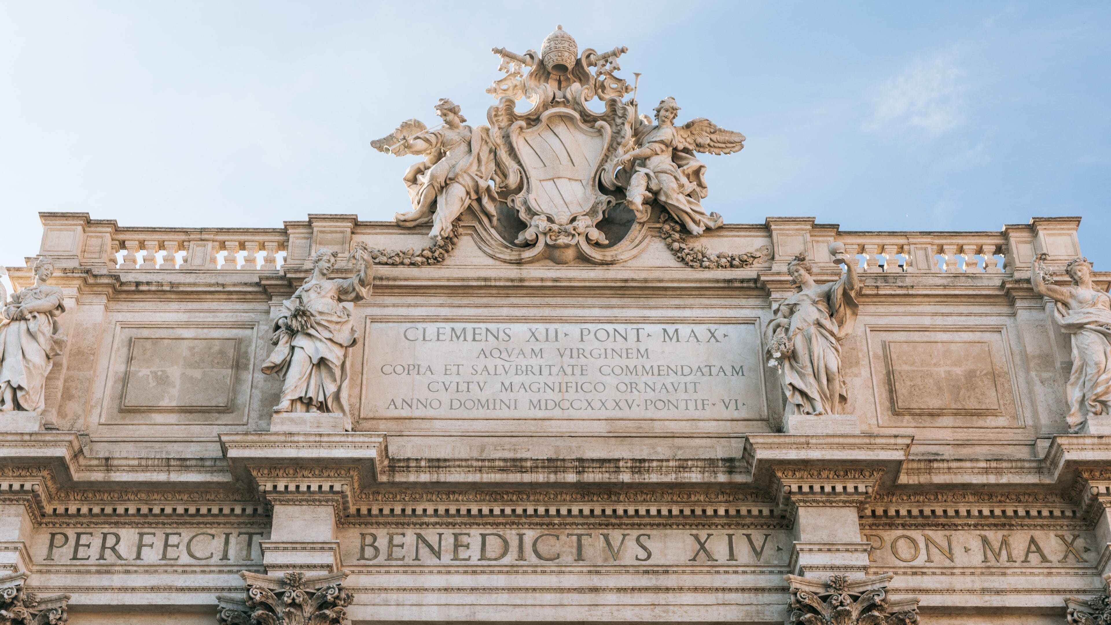 Trevi Fountain featuring heritage architecture and signage