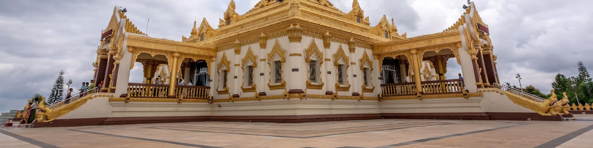 A golden temple with intricate architecture and a large open courtyard.
