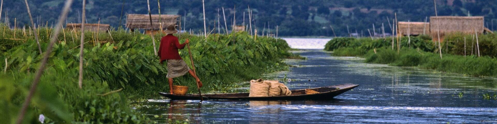 Myanmar, Shan State, Inle Lake, man tending to floating island