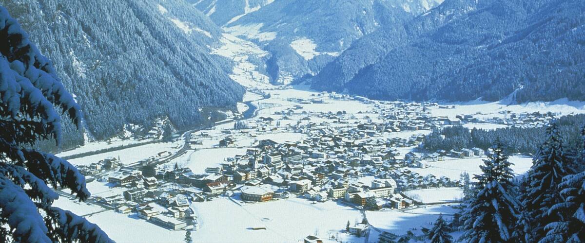 A snow-covered mountain town nestled between snow-capped peaks.