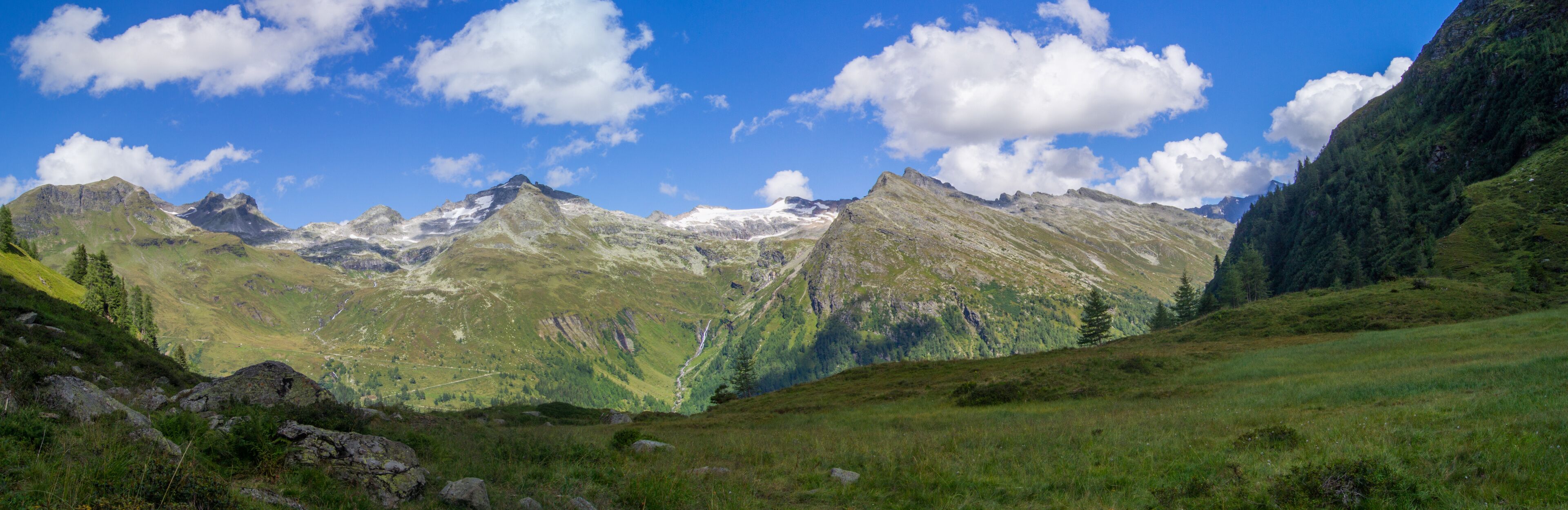 A mountain range with a valley and a river.